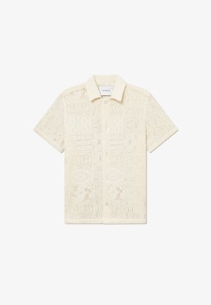 Camisa de botão de manga curta, em creme claro, feita de um tecido de crochê texturizado, com padrões geométricos e um design de colarinho clássico.
