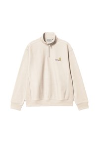 Sudadera de color beige claro con medio cierre. Presenta un logo de Carhartt en dorado y marrón en el pecho. Textura suave y corte relajado.