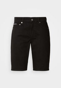 Shorts en denim noir à coupe droite, avec des accents métalliques, cinq poches et une fermeture éclair. Texture lisse avec un minimum de coutures.
