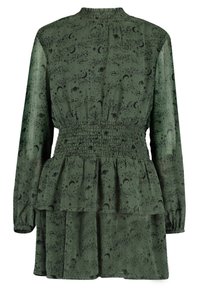 Zielona sukienka z marszczonym pasem, długimi rękawami i warstwowym dołem. Posiada czarny wzór kosmiczny z gwiazdami, księżycami i planetami.