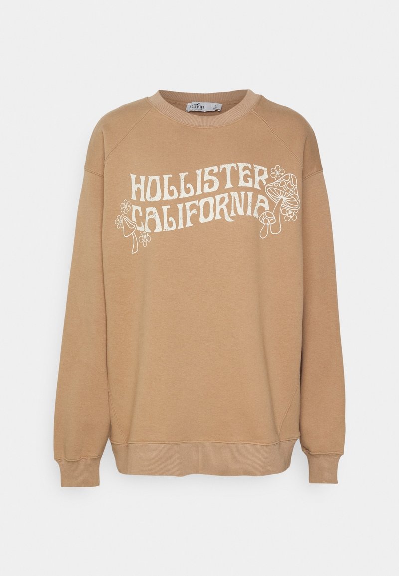 Brun sweatshirt med vit text "HOLLISTER CALIFORNIA" och blommiga detaljer. Har ribbade ärmslut och midja samt en rundad halsringning.