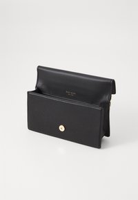 Black leather clutch with a textured finish, gold hardware, and a front snap closure. Interior compartment with logo detail.