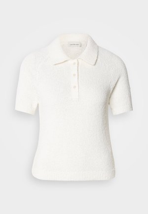 Kurzärmliges, kragenloses Poloshirt aus strukturiertem, cremefarbigen Stoff. Mit einer Knopfleiste mit drei Knöpfen und einem gerippten Saum. Weiches, lässiges Design.