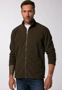 Giacca in pile marrone scuro con zip frontale, colletto alto e maniche lunghe. Tessuto morbido, presenta un piccolo logo sull'orlo.