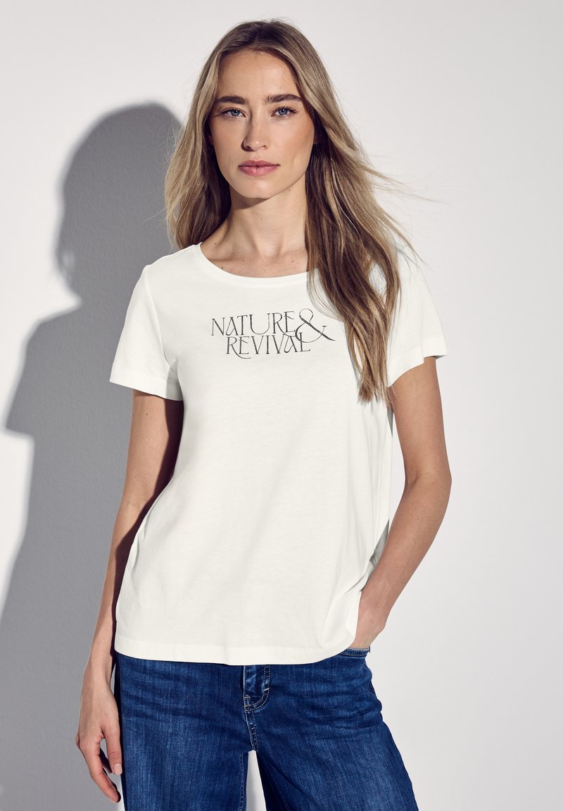 T-shirt blanc à manches courtes avec le texte "NATURE & REVIVAL" en noir, avec une coupe décontractée et en matériau en coton doux. Convient pour un usage décontracté.