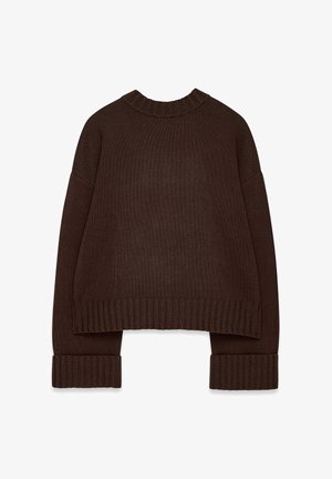 Rudas megztinis su apvaliu gipiūro apykakle, nuleistais pečiais ir plačiomis gipiūro rankovėmis. Trumpa ilgis su tekstūruotu paviršiumi.