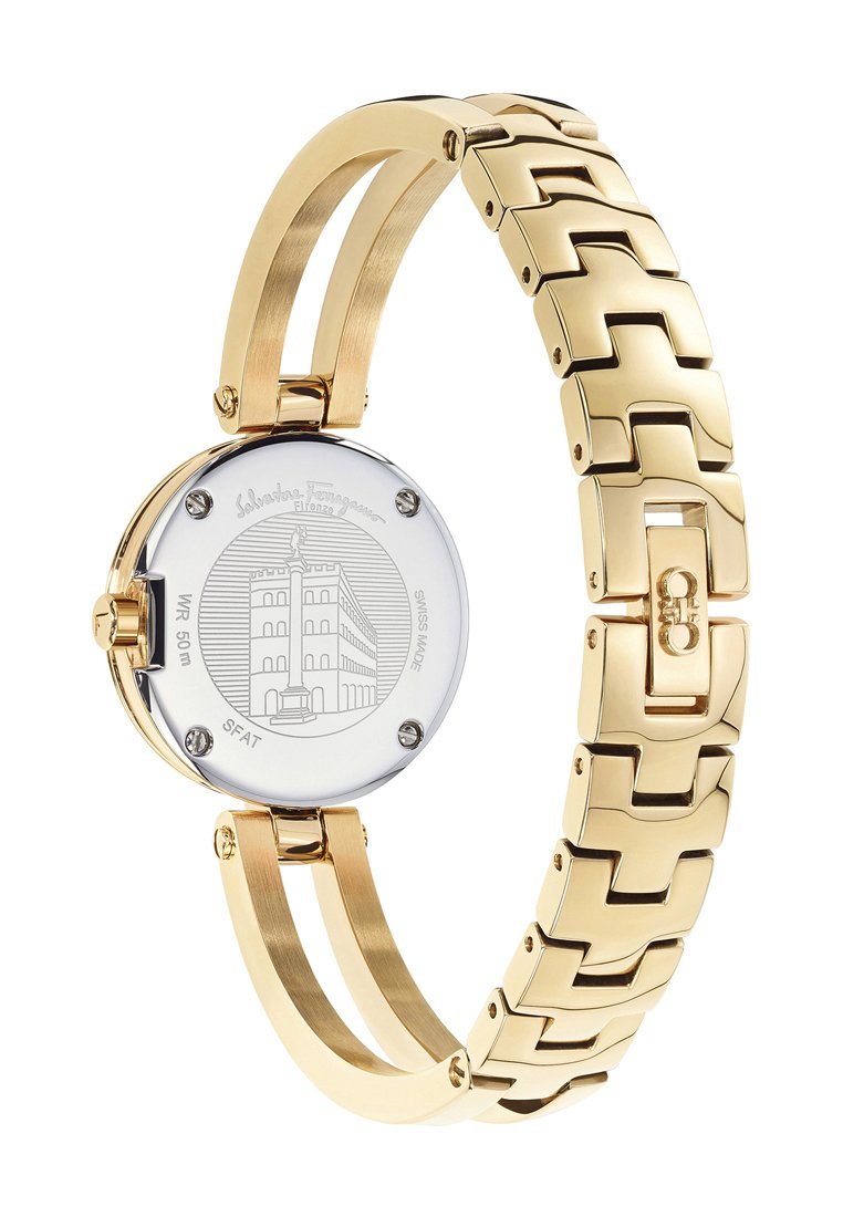 Orologio in metallo dorato con bracciale a maglie, quadrante rotondo e design inciso sul retro che rappresenta un edificio. Resistente all'acqua fino a 50 metri.