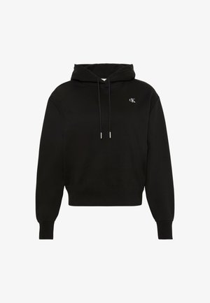 Svart hettegenser med kengurulomme og snøring i hetten. Har en diskret brodert hvit logo på brystet. Mykt stoff, avslappet passform.