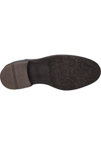 Suela de zapato negra con un patrón texturizado; cuenta con goma lisa en el talón y una superficie con patrón para tracción y agarre.
