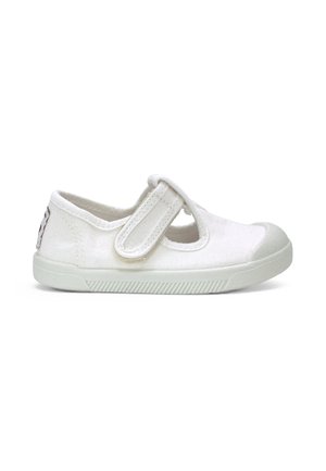 Chaussure enfant en toile blanche avec bride auto-agrippante et semelle en caoutchouc, vue de côté sur fond blanc.
