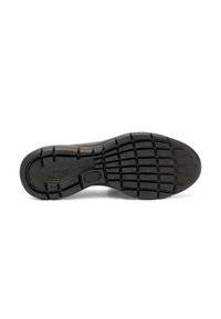 Semelle de chaussure en caoutchouc noir présentant un motif de grip texturé avec un design en zigzag et un détail de marque bien visible. Construction plate avec bords arrondis.