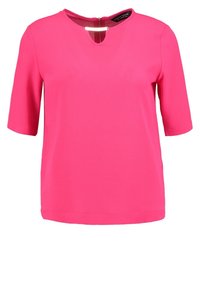 Top a maniche corte in tessuto di un vivace rosa, con colletto rotondo e dettaglio a chiave. Zip sul retro per la chiusura. Finitura testurizzata.