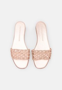 Světle růžové skluzné sandály s širokým, texturovaným pleteným páskem a hladkou, plochou podrážkou. Jednoduchý design se čtveratým špičkou.