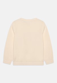 Crème-kleurige sweatshirt met een zachte textuur, lange mouwen en een ronde halslijn. Voorzien van ribgebreide manchetten en zoom, eenvoudig ontwerp, geen patronen.