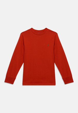 Punane pika varrukaga ümar kaelusega särk väikese rohelise logoga vasakul rinnal valgel ühevärvilisel taustal.