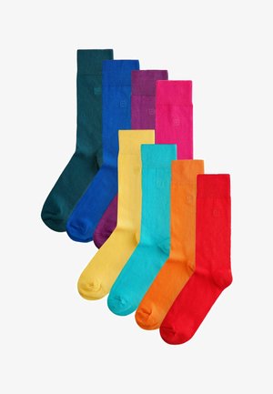 Set aus acht bunten Socken mit gerippten Bündchen. Die Farben sind dunkelgrün, blau, lila, pink, gelb, türkis, orange und rot.