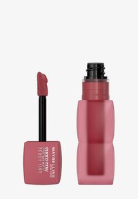 Prodotto labbra Maybelline Super Stay Teddy Tint, con applicatore morbido, contenitore quadrato rosa e tappo a vite elegante rosa.