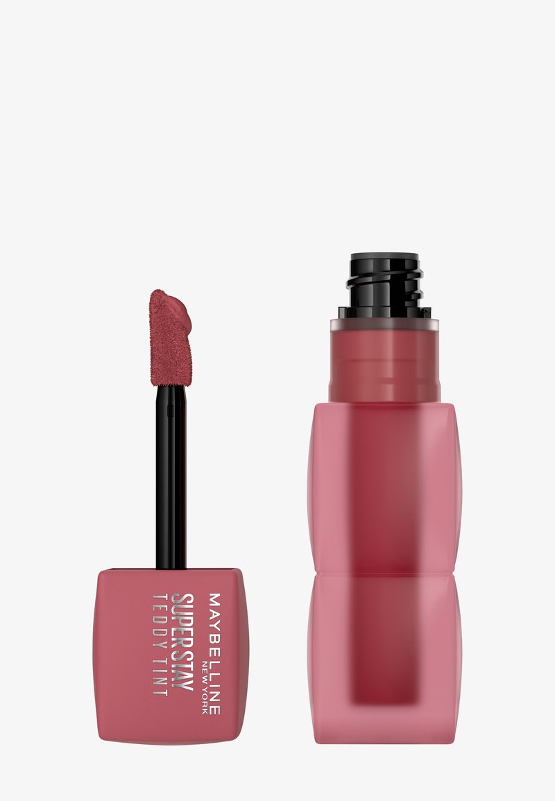 Prodotto labbra Maybelline Super Stay Teddy Tint, con applicatore morbido, contenitore quadrato rosa e tappo a vite elegante rosa.