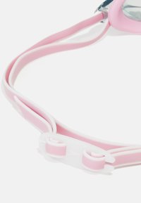 Pink swimming goggles with flexible silicone straps, featuring a white accent and adjustable clips for a secure fit.