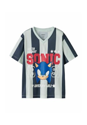 Kortærmet V-hals skjorte med sort-hvide lodrette striber, med et stort Sonic the Hedgehog ansigt og tekst "Gotta Go Fast Sonic Unstoppable 1991".