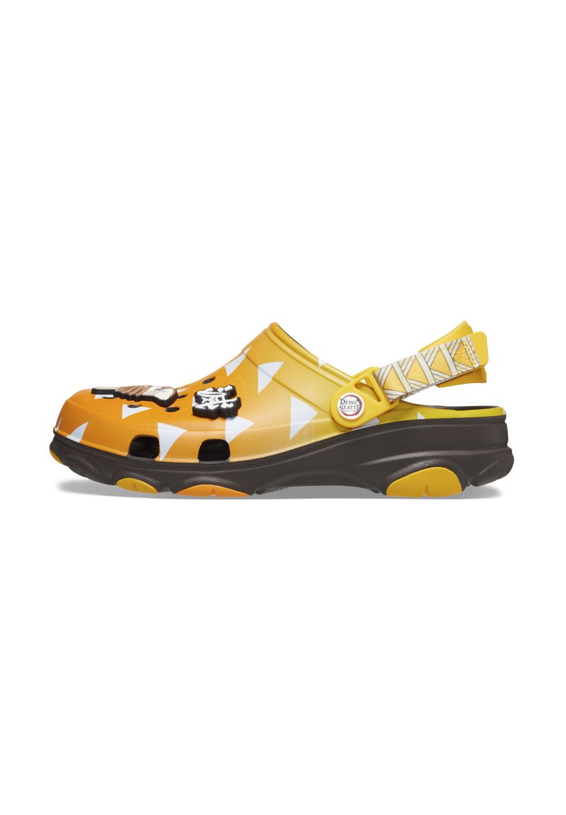 Yellow and orange clogs with white triangle pattern, black accents, and textured sole. Adjustable strap with geometric design on the side.