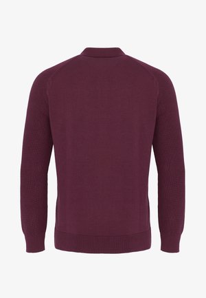 Ciemnofioletowy, długi sweter z dzianiny z długim rękawem, widoczny od tyłu, z prążkowanym obszyciem na dole, mankietach i małym kołnierzykiem.