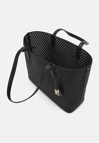 Zwarte geweven totebag met twee leren handvatten. Heeft een gestructureerde vorm en goudkleurige hardware-accenten. Textuurmateriaal, lichtgewicht.