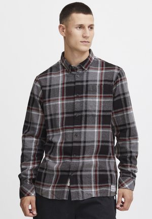 Gray and black plaid button-up shirt with red accents and a chest pocket. Soft texture, long sleeves, and rounded hem with label detail.