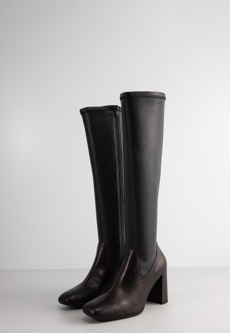 Ein Paar schwarze, knielange Lederstiefel mit Blockabsätzen und seitlichen Reißverschlüssen, aufrecht auf einer neutralen Oberfläche vor einem schlichten Hintergrund stehend.