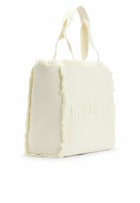 Borsa tote bianca con dettaglio di bordo sfrangiato, con logo "HUGO" in rilievo sul lato. Realizzata in tessuto strutturato con manici eleganti.
