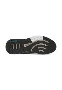 Reebok'i sneakeri tald, mis on varustatud musta ja valge kummiga, tekstuuritud haardemustriga, kaarjate aktsentidega ja teal värvi logoga.
