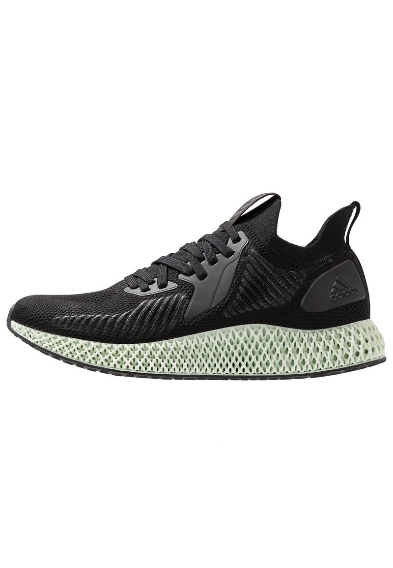 Zapatilla negra con una parte superior de malla texturizada, que presenta un panel de goma negra y una suela de patrón enrejado de color verde claro.