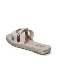 Light beige sandal with crisscross straps made of soft material, featuring a textured jute-wrapped sole and flat design.
