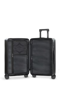 Black suitcase with a hard shell, dual wheels, and retractable handle. Interior features zippered mesh pocket and spacious main compartment.