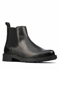Stivale Chelsea in pelle nera con pannelli elastici sui lati, punta arrotondata e suola in gomma texturizzata con tacco basso per una buona aderenza.