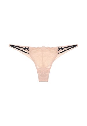 Perizoma in pizzo beige con doppie fascette nere ai lati e piccoli fiocchi neri vicino alla cintura.