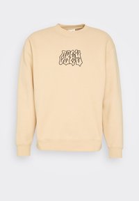 Béžová mikina s kulatým výstřihem a černou grafikou "OBEY". Vyrobena z měkké látky, s žebrovanými manžetami a lemem, nabízející pohodlný střih.