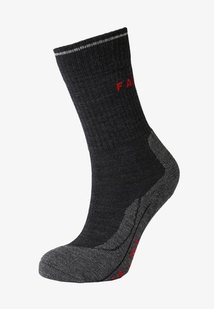 Donkergrijze sok met een geribde bovenkant, versterkte hiel en teen. Heeft rode tekst en een contrasterende donkergrijze accent op de zool.