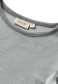 Gray striped long-sleeve shirt with a rounded neckline. Label reads "WHEAT" and size "4Y 104." Soft texture with a ribbed collar.
