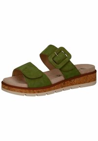 Groene suède slide-sandaal met twee verstelbare banden en een gesp, kurkachtige middenzool en een witte rubberen loopzool. Heeft een gladde textuur.
