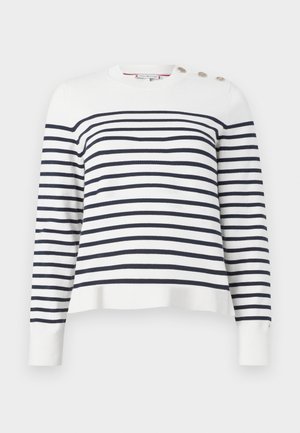 Hvit og marineblå stripete genser med rund hals, lange ermer og knappdetaljer på skulderen. Strikket tekstur, avslappet passform.
