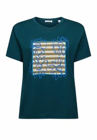 Teal bomull t-shirt med kort ärm som har en fyrkantig blomdesign i blått med vertikala randiga mönster i beige. Rund halsringning.