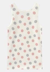 Ermeløs tanktop i kremfarget stoff, med et prikkete mønster i rosa, grått og marine. Glatt tekstur med rund halslinning.