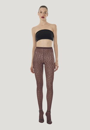 Genomskinliga bruna strumpbyxor med prickigt mönster, hög midja och utskurna partier vid anklarna, kombinerade med en svart axelbandslös topp. Slät, lättviktig tyg.