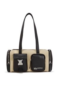 Béžová plátená kabelka s čiernymi koženými doplnkami, vybavená dvojitými bočnými zipsami, s detailom pracky a odnímateľnou malou kapsičkou.