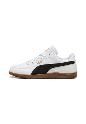 Low-top white Puma sneaker with black side stripe, gum sole, white laces, and gold Puma logo on side and tongue.