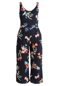 Blommig byxdress i marinblått med rundad halsringning, vida ben och färgglada botaniska mönster. Tillverkad av lätt och mjukt tyg.