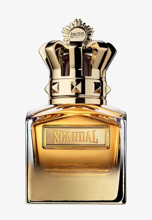 Perfume bottle with gold gradient glass and a large gold crown-shaped cap, labeled "Scandal" by Jean Paul Gaultier.