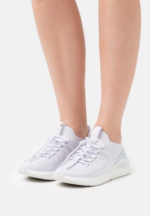White knitted sneakers with a stretchy upper and lace-up design, featuring a textured sole and subtle blue accent on the heel.