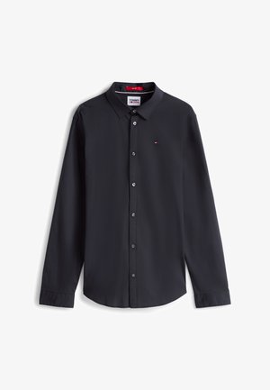 Juoda ilgomis rankovėmis marškiniai su sagomis ant apykaklės, su mažyliu logotipu ant krūtinės, pagaminti iš lygaus audinio, laisvo kirpimo.